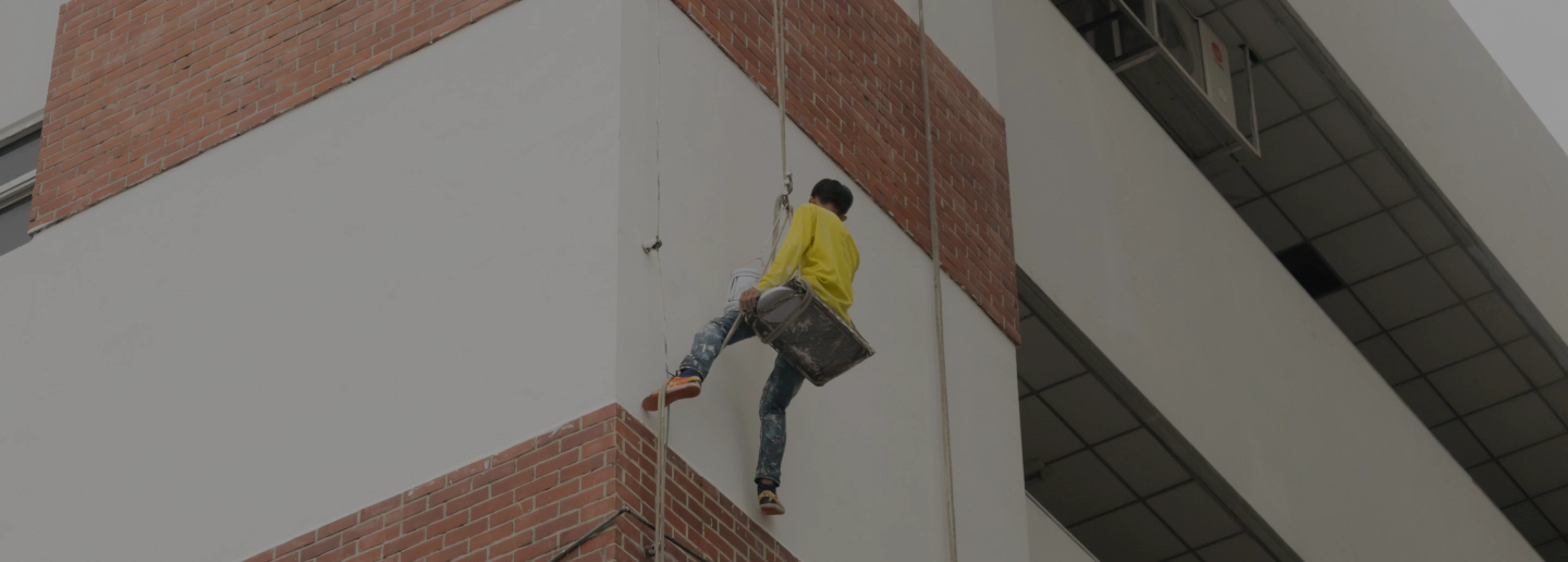 man painting commercial building